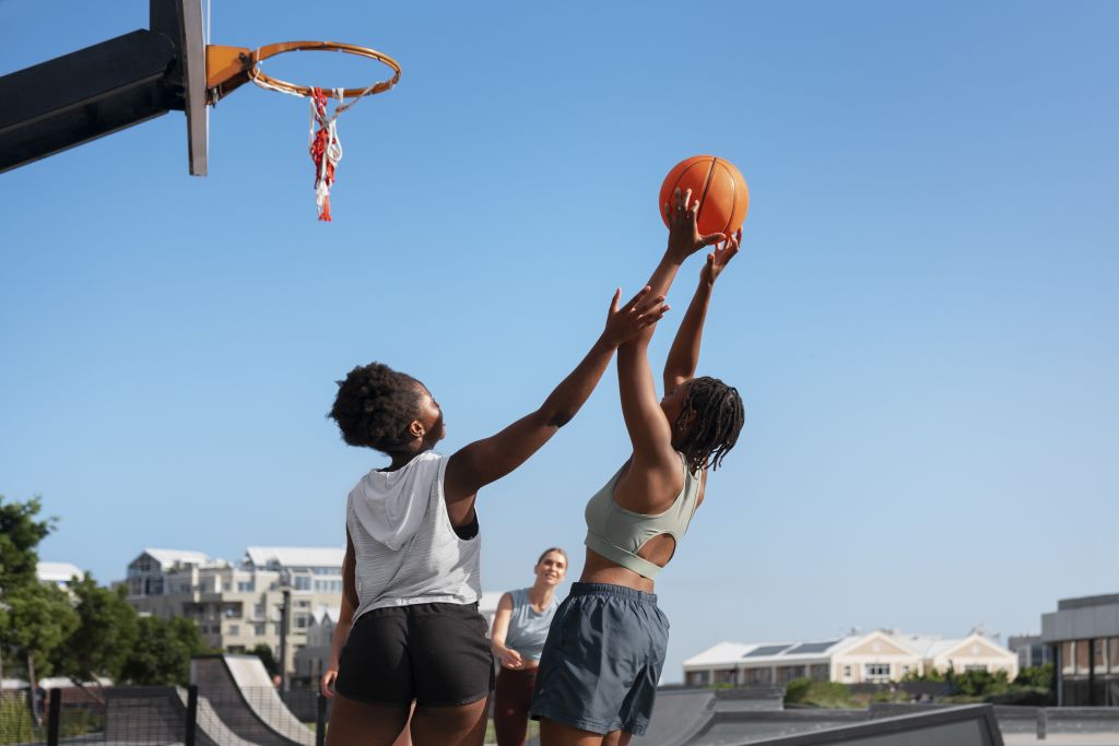 side-view-female-friends-playing-basketball (1)