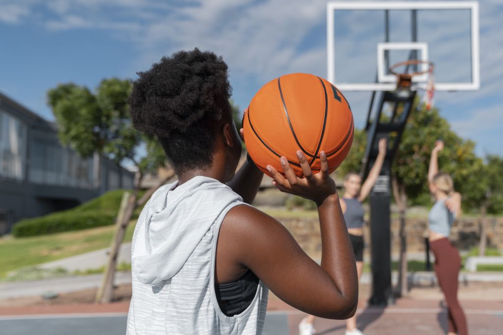 side-view-female-friends-playing-basketball